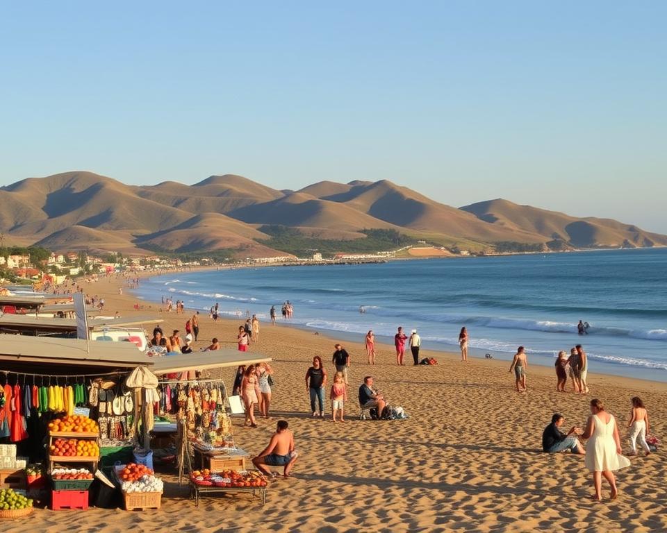 A picturesque scene of the Pacific coastline in Ensenada, Mexico, showcasing a vibrant beach with golden sands and gentle waves. In the foreground, local vendors display colorful markets filled with fresh seafood, fruits, and handcrafted souvenirs, inviting visitors to indulge in the local culture. The middle ground features people in modest summer attire enjoying the sunny weather, while families picnic and children play near the shoreline. In the background, rolling hills adorned with lush greenery meet the deep blue ocean under a clear sky, creating a serene atmosphere. Set during the golden hour with warm lighting that casts soft shadows, this scene captures the essence of relaxation and enjoyment, highlighting the beauty of Baja California's coastal charm.