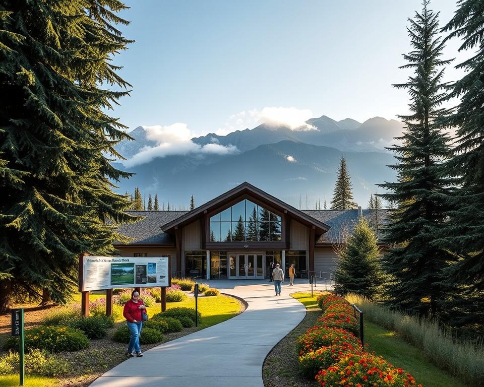 A picturesque view of the Revelstoke National Park Visitor Centre, showcasing its modern architectural design nestled among towering evergreen trees. In the foreground, a well-maintained path leads to the entrance, flanked by vibrant wildflowers and informational signs about local wildlife. The middle ground features the visitor centre itself, with large glass windows reflecting the surrounding landscape, inviting visitors in for information. In the background, rugged mountains rise majestically, partially shrouded in mist, under a soft morning light that casts gentle shadows. A serene atmosphere suggests adventure, while a few visitors in modest casual clothing can be seen exploring the area, capturing the spirit of outdoor exploration. The scene is captured from a slightly elevated angle, emphasizing both the visitor centre and its stunning natural surroundings, enhanced with a warm, inviting glow.